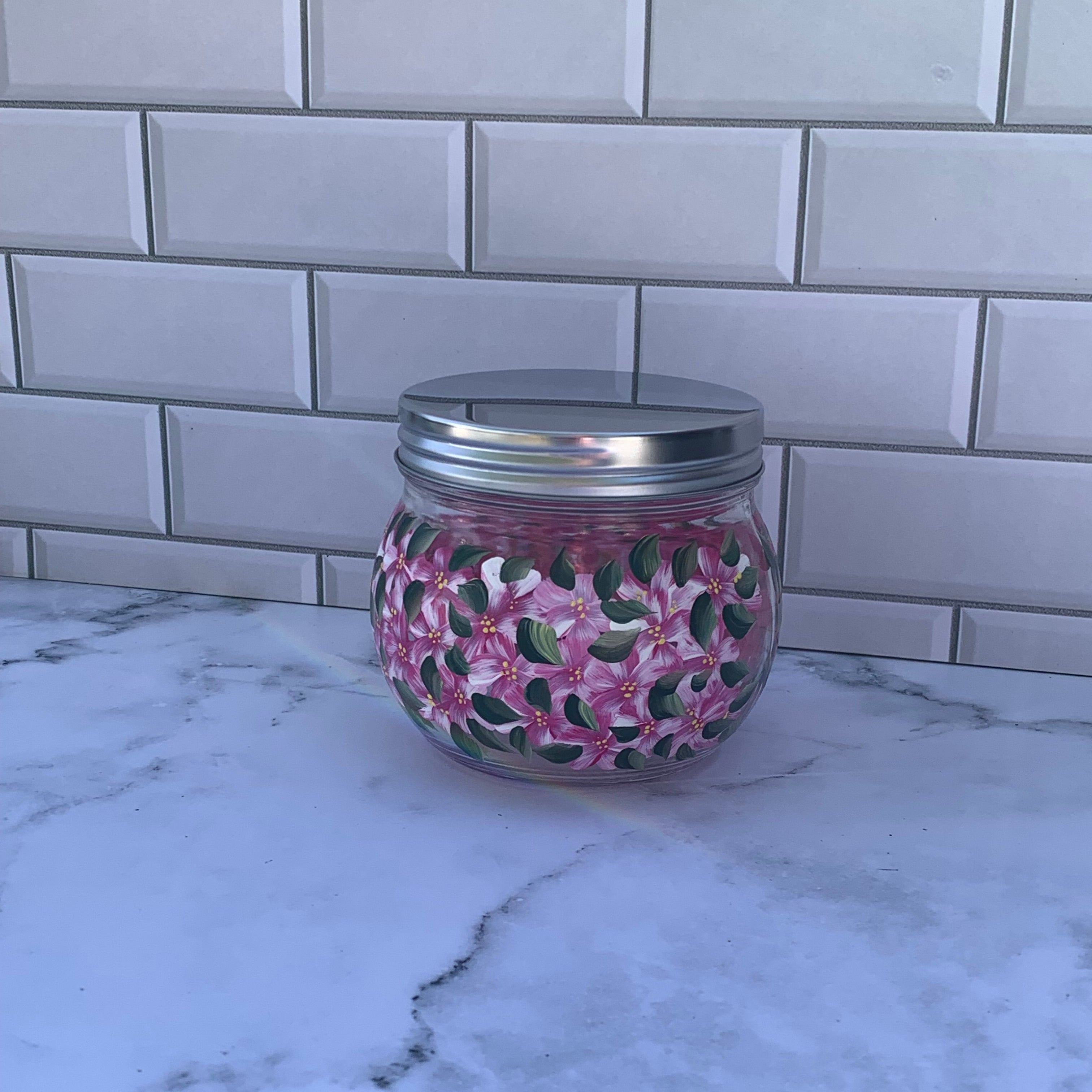 18 oz round glass jar with metal screw on lid, hand painted all around with pink floral design.