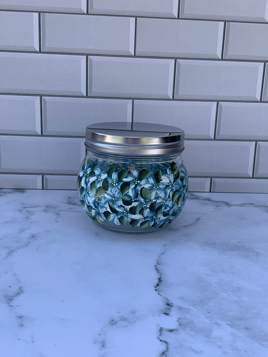 18 oz round glass jar with screw on metal lid hand painted with blue hydrangeas on all sides